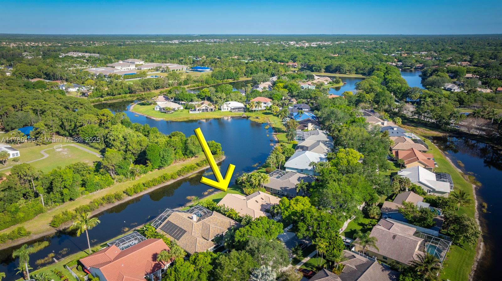 18295 Lake Bend Drive Jupiter, FL 33458 - Photo 50 of 64 an aerial view of residential houses with outdoor space and trees