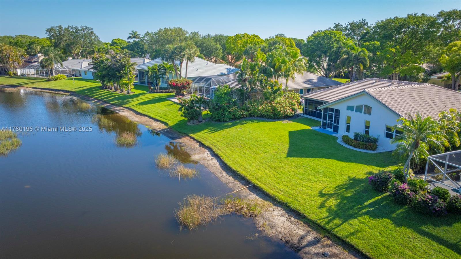 18295 Lake Bend Drive Jupiter, FL 33458 - Photo 55 of 64 a view of a house with swimming pool and yard