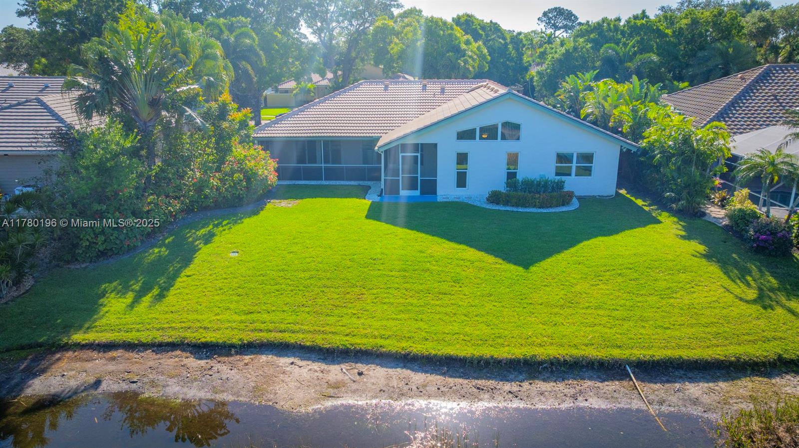 18295 Lake Bend Drive Jupiter, FL 33458 - Photo 56 of 64 a aerial view of a house next to a yard