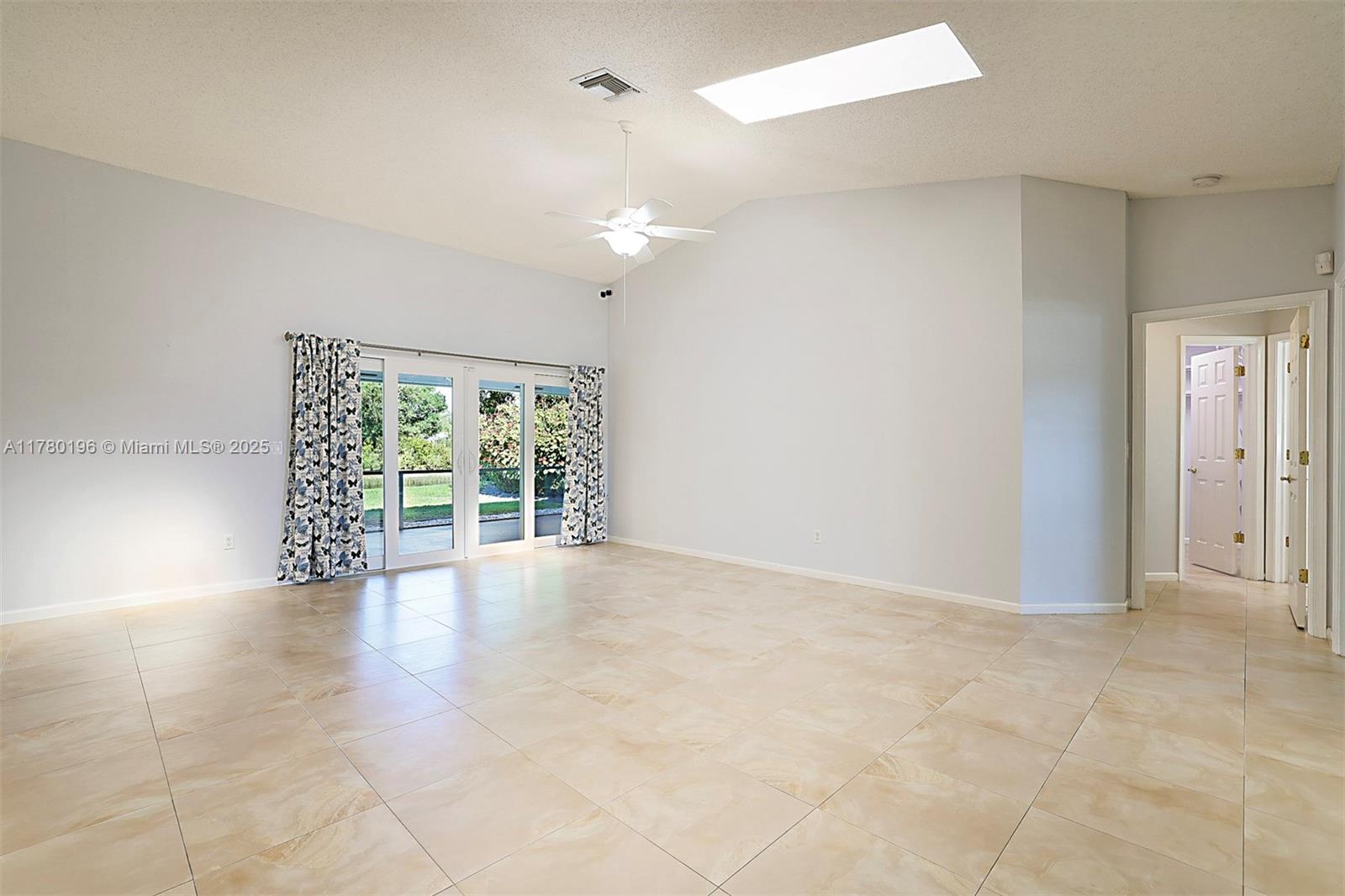 18295 Lake Bend Drive Jupiter, FL 33458 - Photo 6 of 64 wooden floor in an empty room with a window