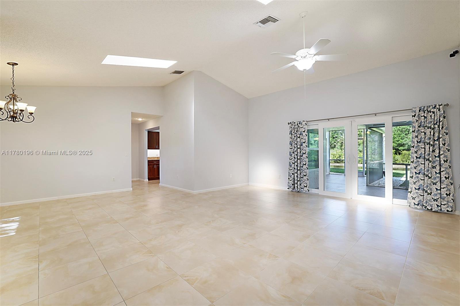 18295 Lake Bend Drive Jupiter, FL 33458 - Photo 8 of 64 a view of a livingroom with an empty space and a window