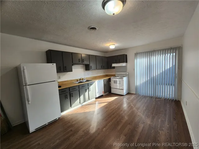 a kitchen with stainless steel appliances a refrigerator sink and microwave
