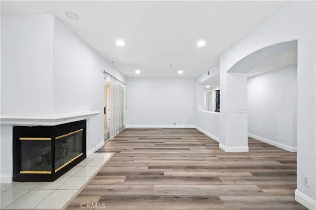 a view of an empty room and wooden floor