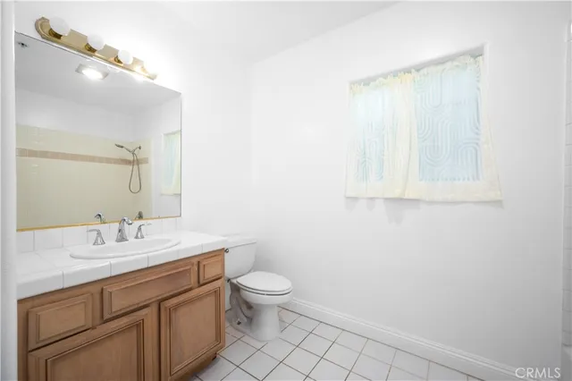 a bathroom with a sink a toilet and vanity