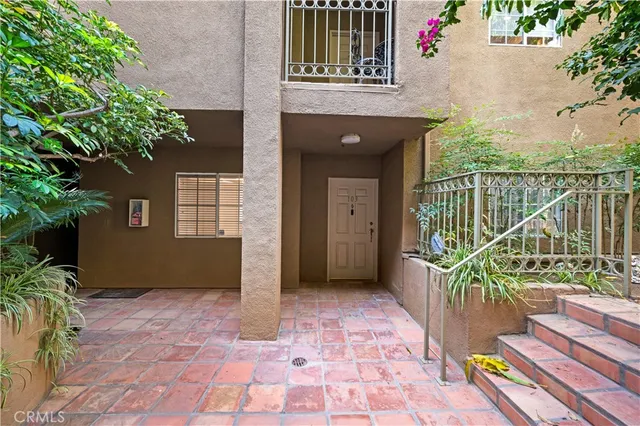 a view of a balcony with wooden floor and fence