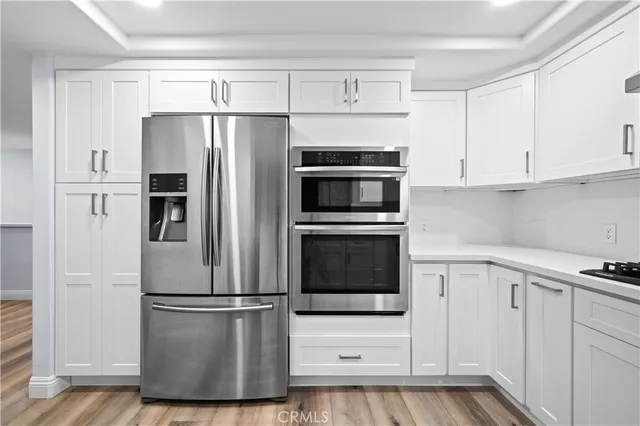 a kitchen with cabinets and stainless steel appliances