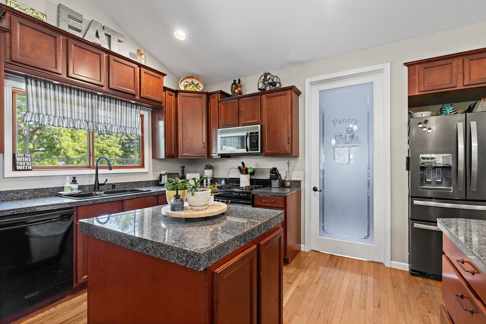1212 Sycamore Road DeKalb, IL 60115 - Photo 14 of 44 a kitchen with granite countertop a sink stove and refrigerator