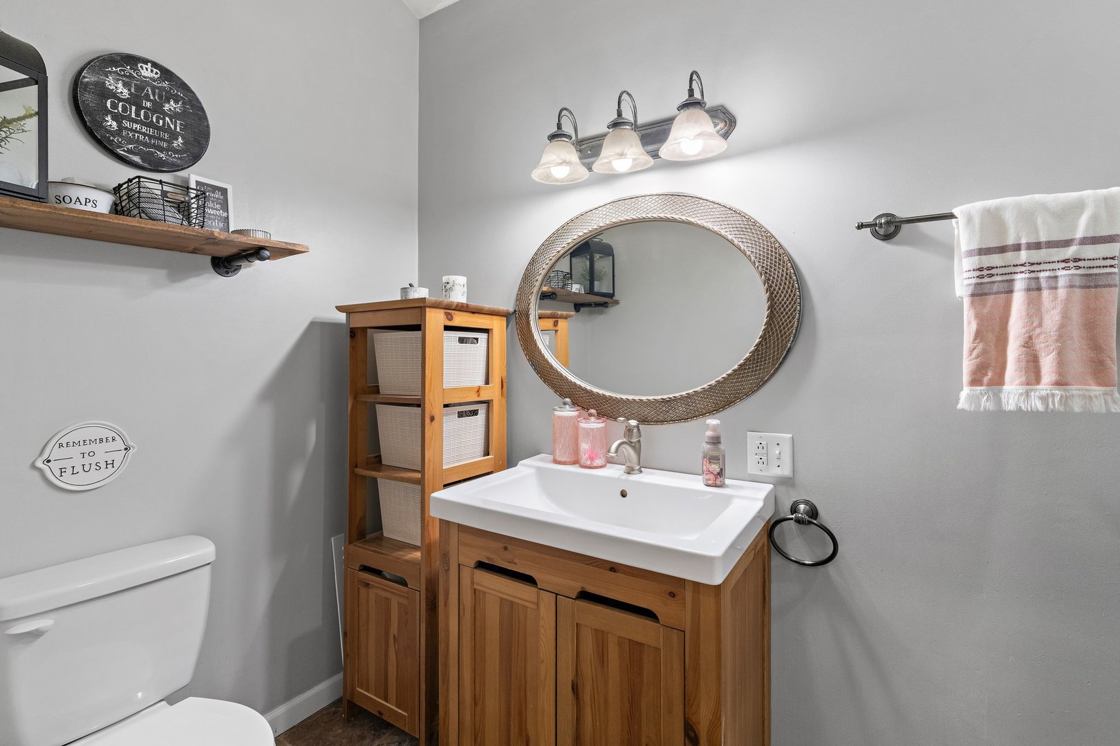 1212 Sycamore Road DeKalb, IL 60115 - Photo 16 of 44 a bathroom with a toilet a sink and a mirror