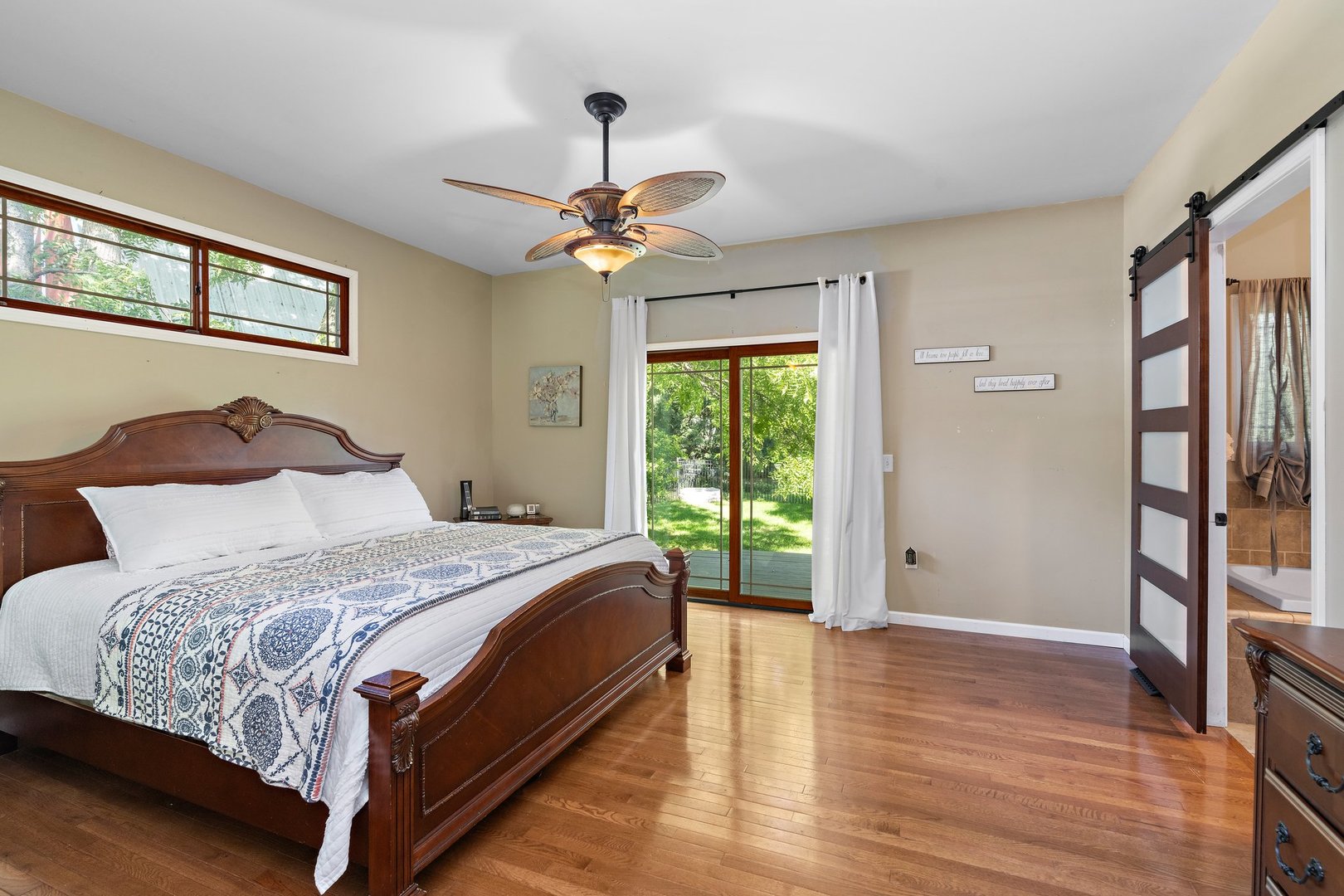 1212 Sycamore Road DeKalb, IL 60115 - Photo 20 of 44 a bedroom with a large bed and a chandelier
