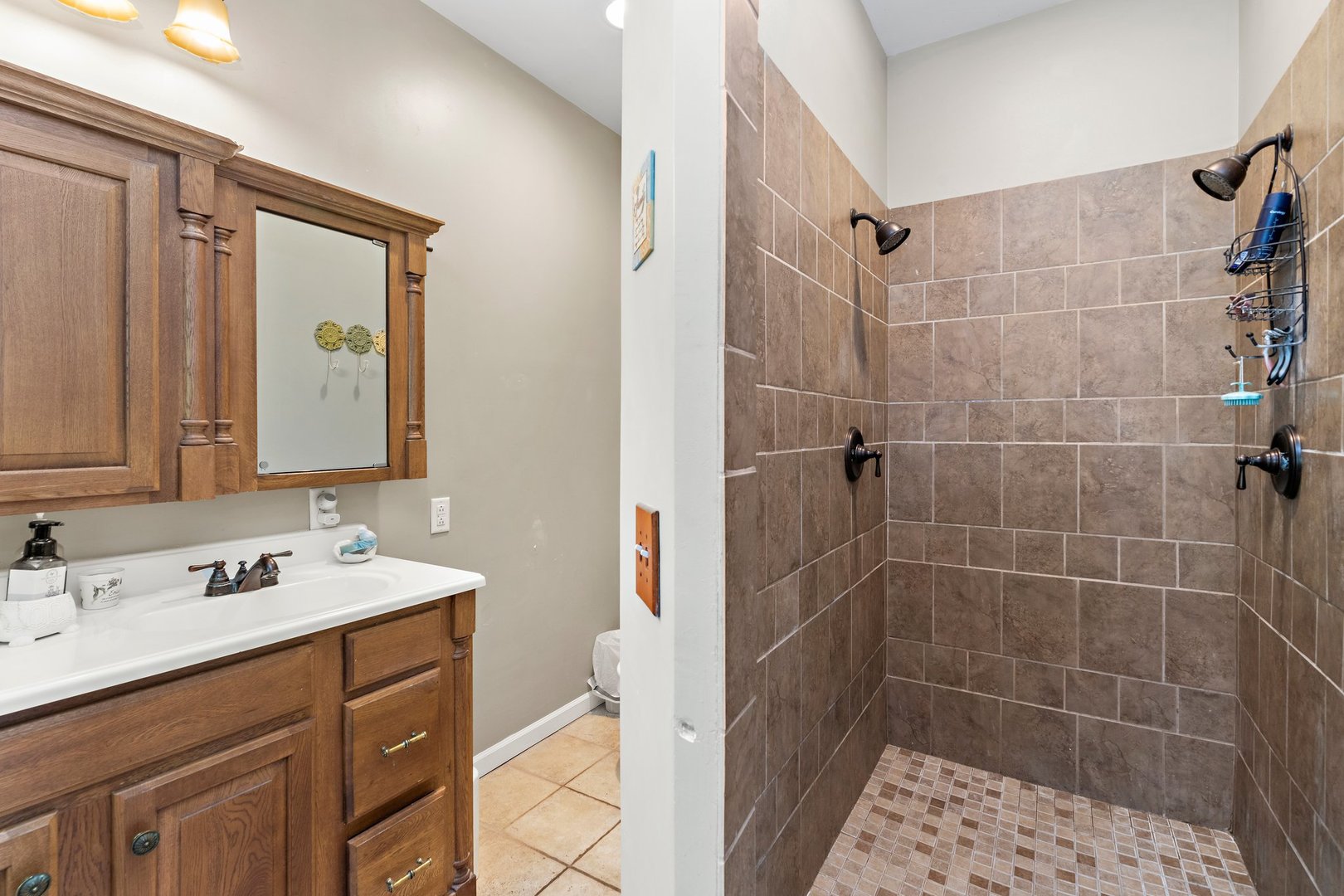 1212 Sycamore Road DeKalb, IL 60115 - Photo 23 of 44 a bathroom with a sink mirror and shower