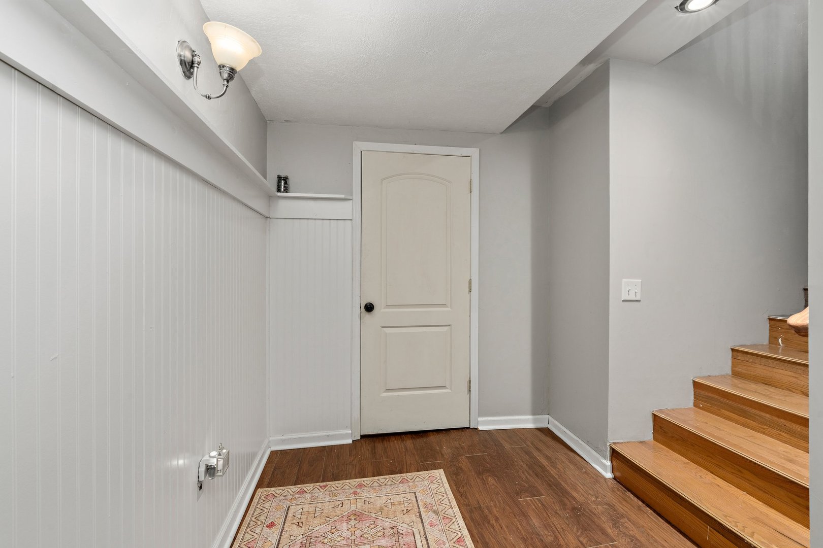 1212 Sycamore Road DeKalb, IL 60115 - Photo 24 of 44 a view of a hallway with wooden floor and staircase