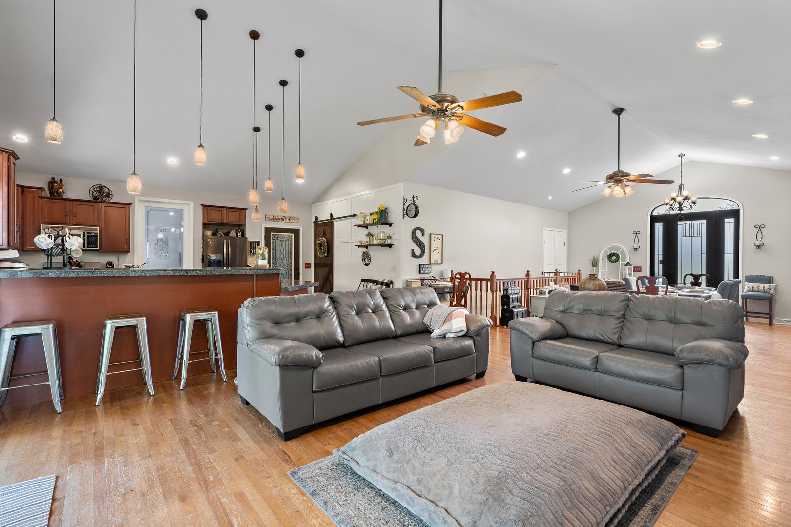 1212 Sycamore Road DeKalb, IL 60115 - Photo 9 of 44 a living room with furniture kitchen view and a chandelier