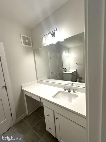 a bathroom with a sink a vanity and mirror