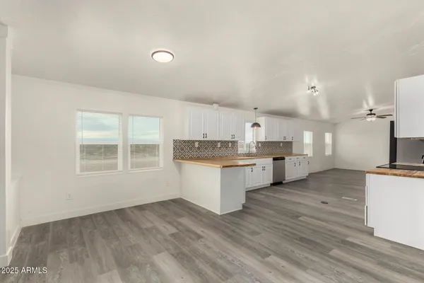 a large kitchen with granite countertop white cabinets and a granite counter tops
