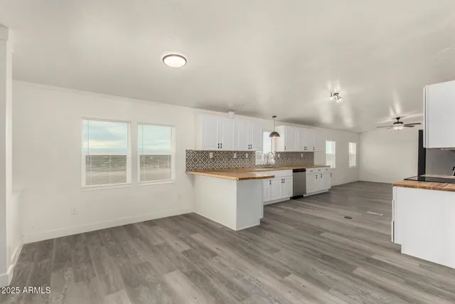a large kitchen with granite countertop white cabinets and a granite counter tops