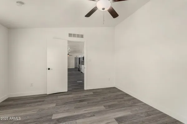 a view of walk in closet with empty racks
