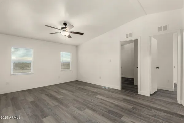 a view of walk in closet with empty racks