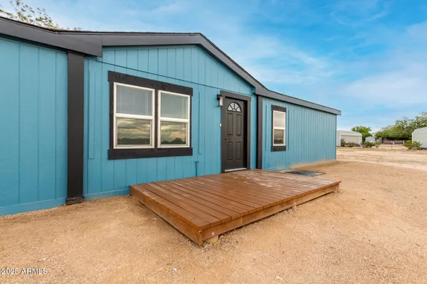 a view of an empty room and wooden floor