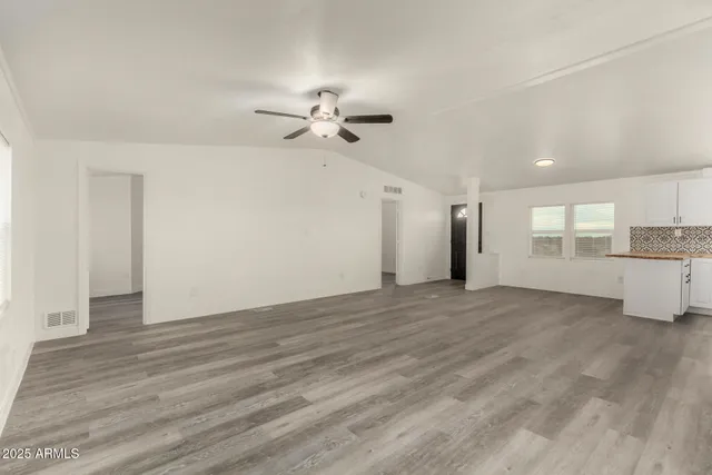 a kitchen with a refrigerator and a stove top oven