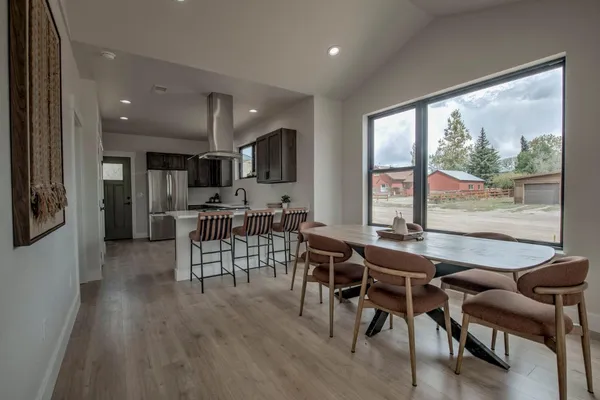 a dining room with furniture and wooden floor