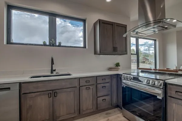 a kitchen with a sink stove and cabinets
