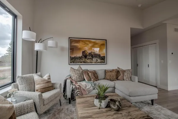 a living room with furniture and a large window