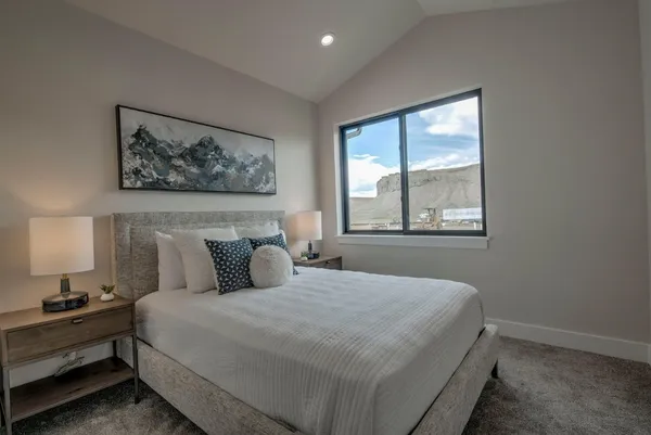 a bedroom with a large bed and a window