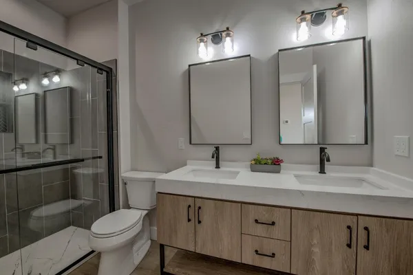 a bathroom with a double vanity sink and a mirror