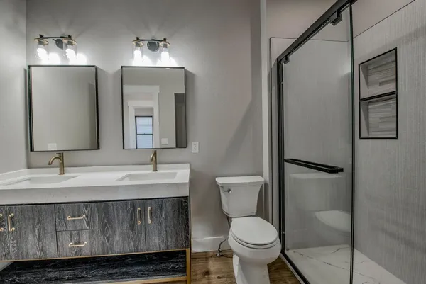 a bathroom with a toilet sink and mirror