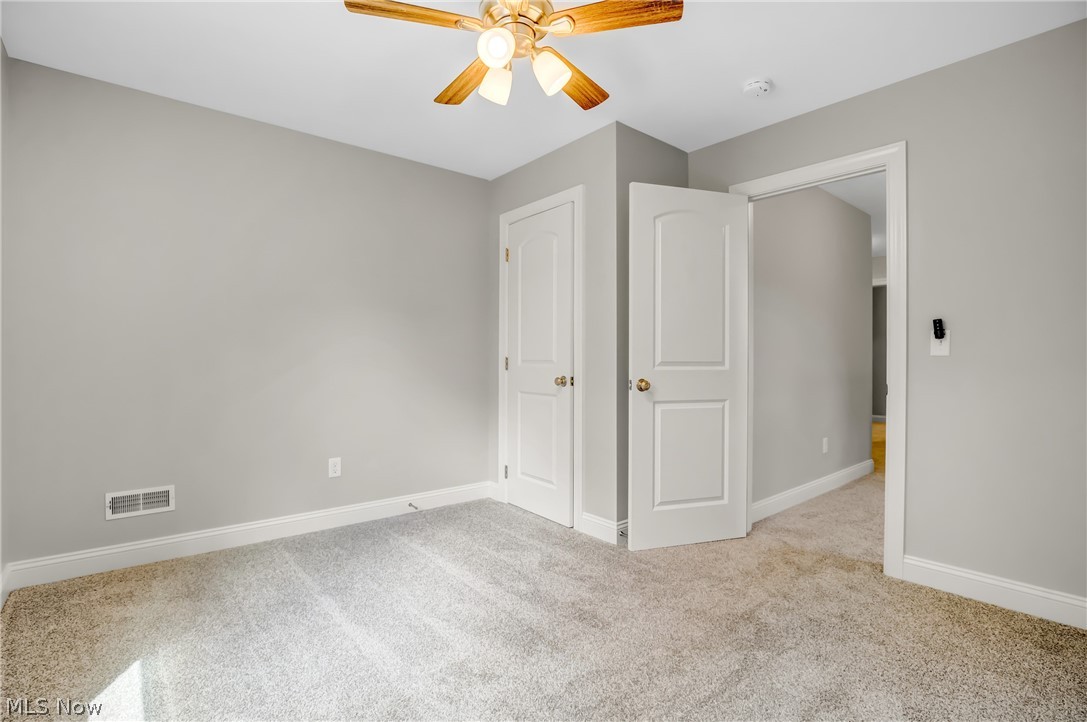 12412 Snow Road Burton, OH 44021 - Photo 36 of 45 Unfurnished bedroom with light carpet and ceiling fan