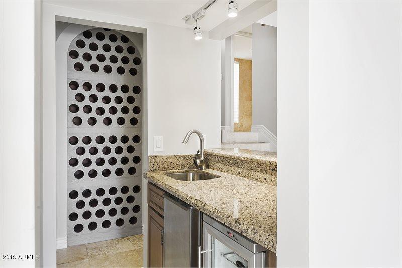 4438 East Camelback Road, Unit 143 Phoenix, AZ 85018 - Photo 8 of 30 a bathroom with a granite countertop sink and a mirror