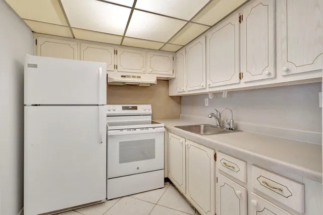 a kitchen with stainless steel appliances granite countertop white refrigerator stove a sink and dishwasher