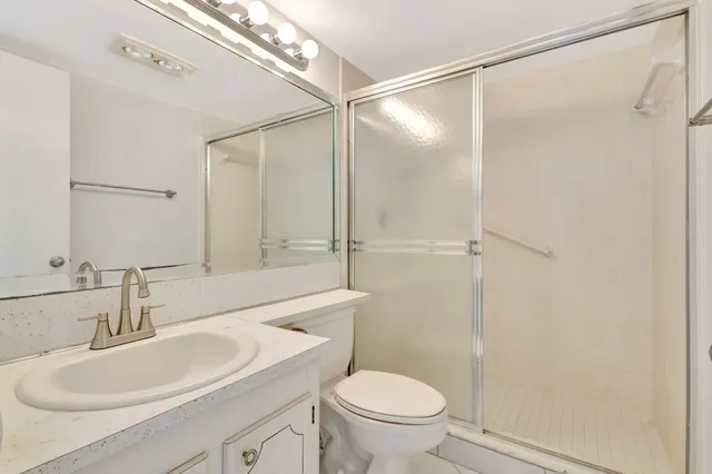 a bathroom with a sink toilet and shower