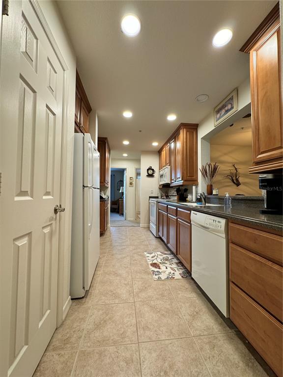 7212 Hamilton Road, Unit 7212 Bradenton, FL 34209 - Photo 11 of 46 a kitchen with stainless steel appliances granite countertop a refrigerator and a sink