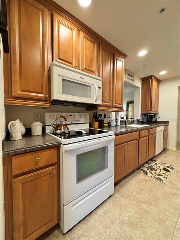 7212 Hamilton Road, Unit 7212 Bradenton, FL 34209 - Photo 13 of 46 a kitchen with stainless steel appliances granite countertop a stove a sink and a microwave