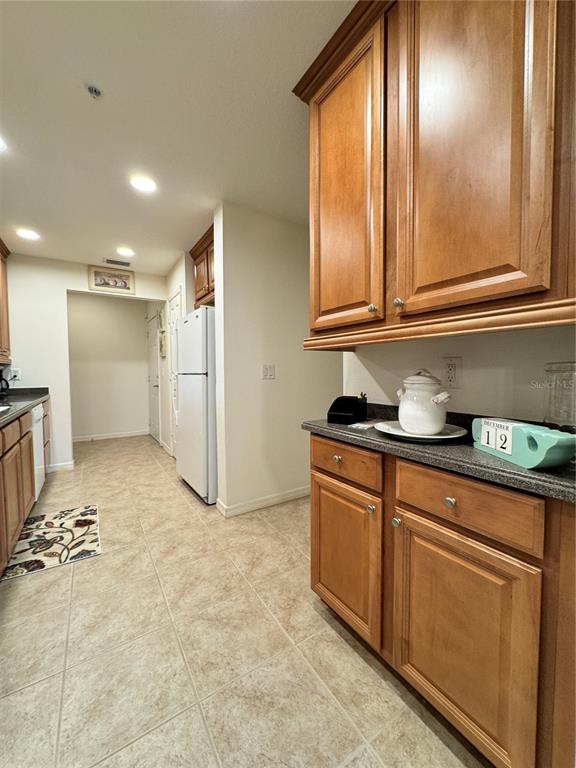 7212 Hamilton Road, Unit 7212 Bradenton, FL 34209 - Photo 14 of 46 a kitchen with granite countertop a refrigerator and a sink