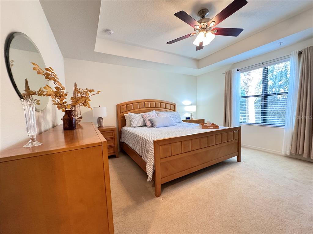 7212 Hamilton Road, Unit 7212 Bradenton, FL 34209 - Photo 17 of 46 a bed room with a bed and a chandelier