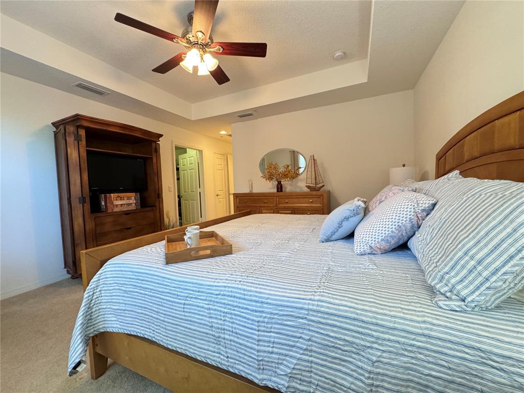 7212 Hamilton Road, Unit 7212 Bradenton, FL 34209 - Photo 18 of 46 a bedroom with a bed and a ceiling fan