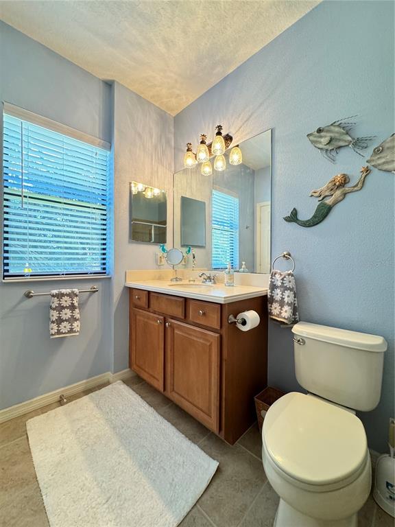 7212 Hamilton Road, Unit 7212 Bradenton, FL 34209 - Photo 22 of 46 a bathroom with a toilet a sink and mirror