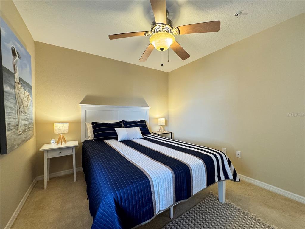 7212 Hamilton Road, Unit 7212 Bradenton, FL 34209 - Photo 24 of 46 a bedroom with a bed and a chandelier