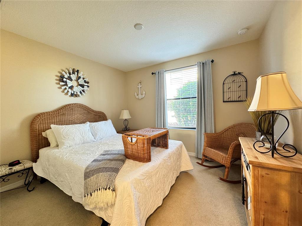 7212 Hamilton Road, Unit 7212 Bradenton, FL 34209 - Photo 26 of 46 a bed sitting in a bedroom next to a window