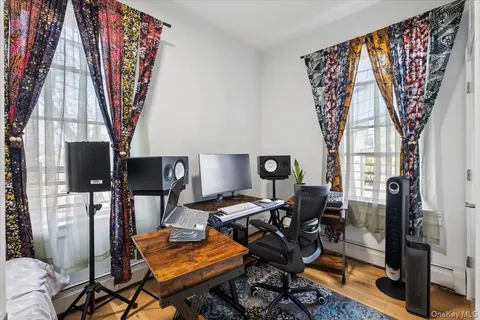 a view of a workspace with furniture and a window
