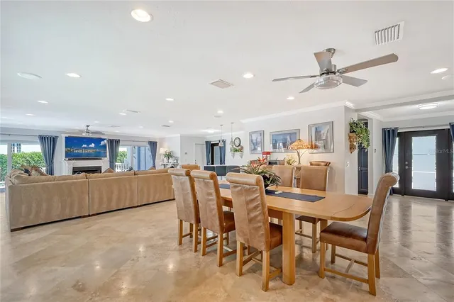 a living room with furniture kitchen view and a chandelier