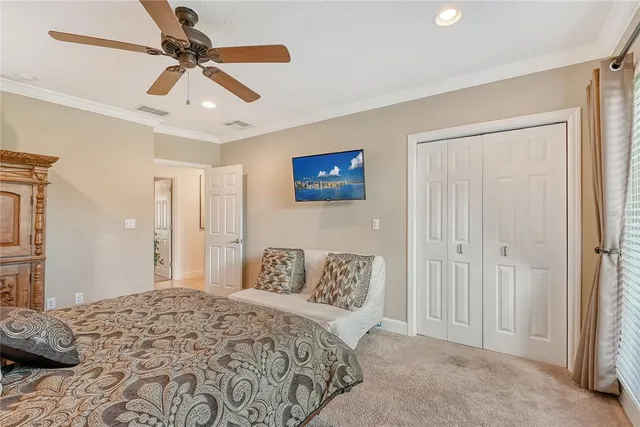a bedroom with a large bed and a chandelier