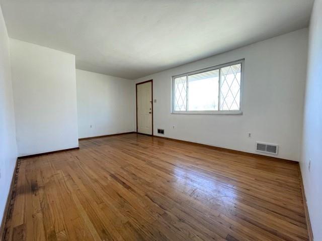 188 Waynesburg Road Washington, PA 15301 - Photo 9 of 17 an empty room with wooden floor and windows