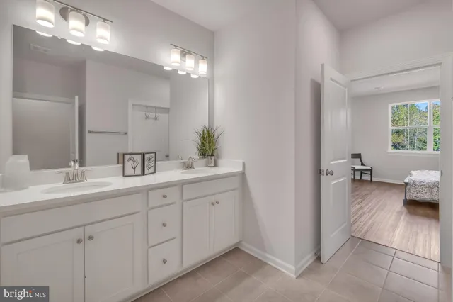 a en suite spacious bathroom with double sink and a mirror