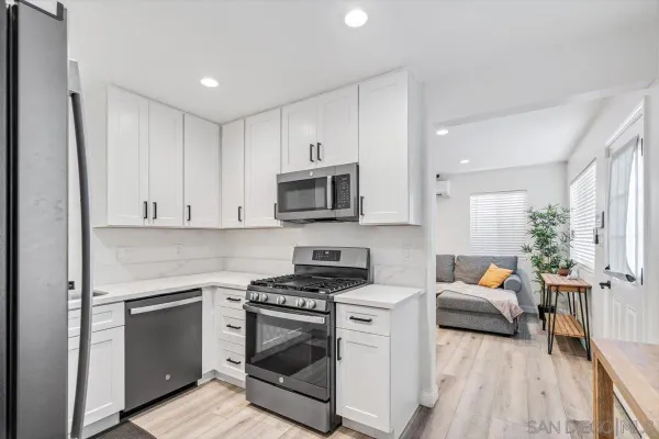a kitchen with stainless steel appliances a stove a sink and a refrigerator