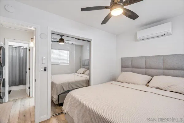 a bedroom with two beds and a chandelier