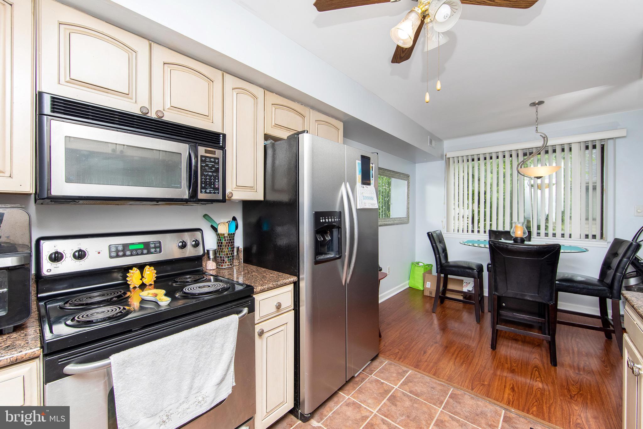 2114 Sandra Road Voorhees, NJ 08043 - Photo 10 of 26 a kitchen with stainless steel appliances granite countertop a stove refrigerator and a microwave