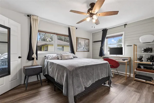 a bedroom with a bed and a chandelier